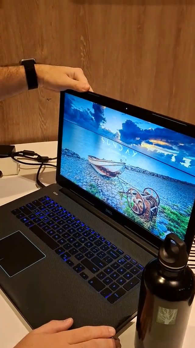 A laptop screen leaning back on its hinge, blurred and dimmed toward the top edge, the WinDuo fold effect mid-close.